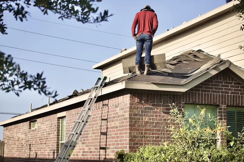 Professional roofer working on a residential roof in Radcliff